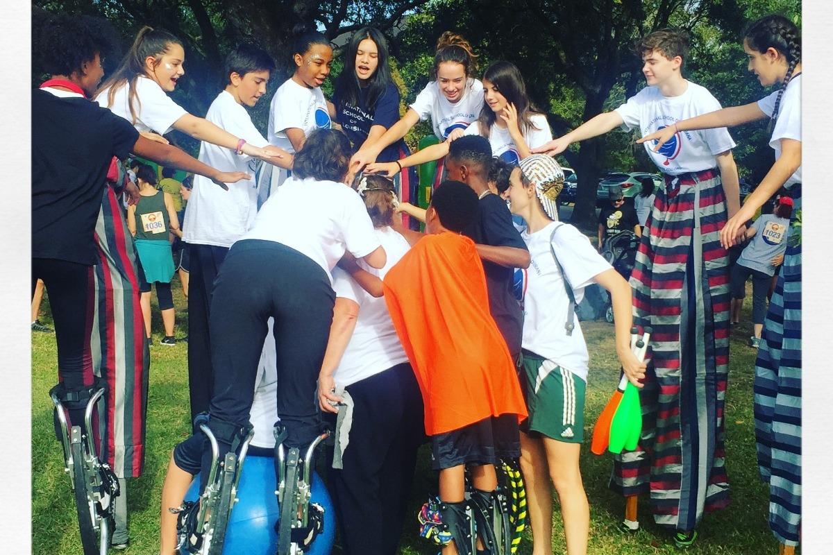 group hug with kids on stilts