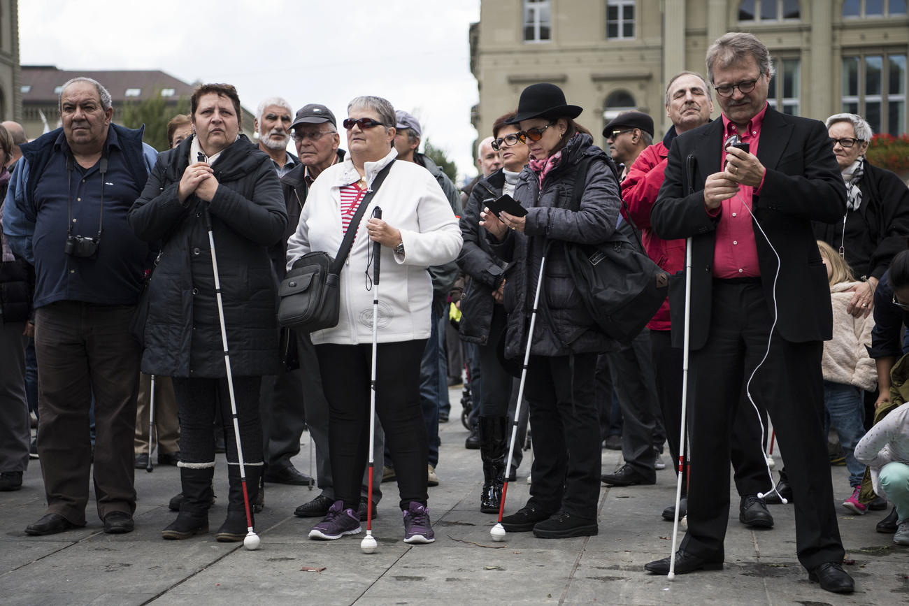 Group of blind people with white walking stick