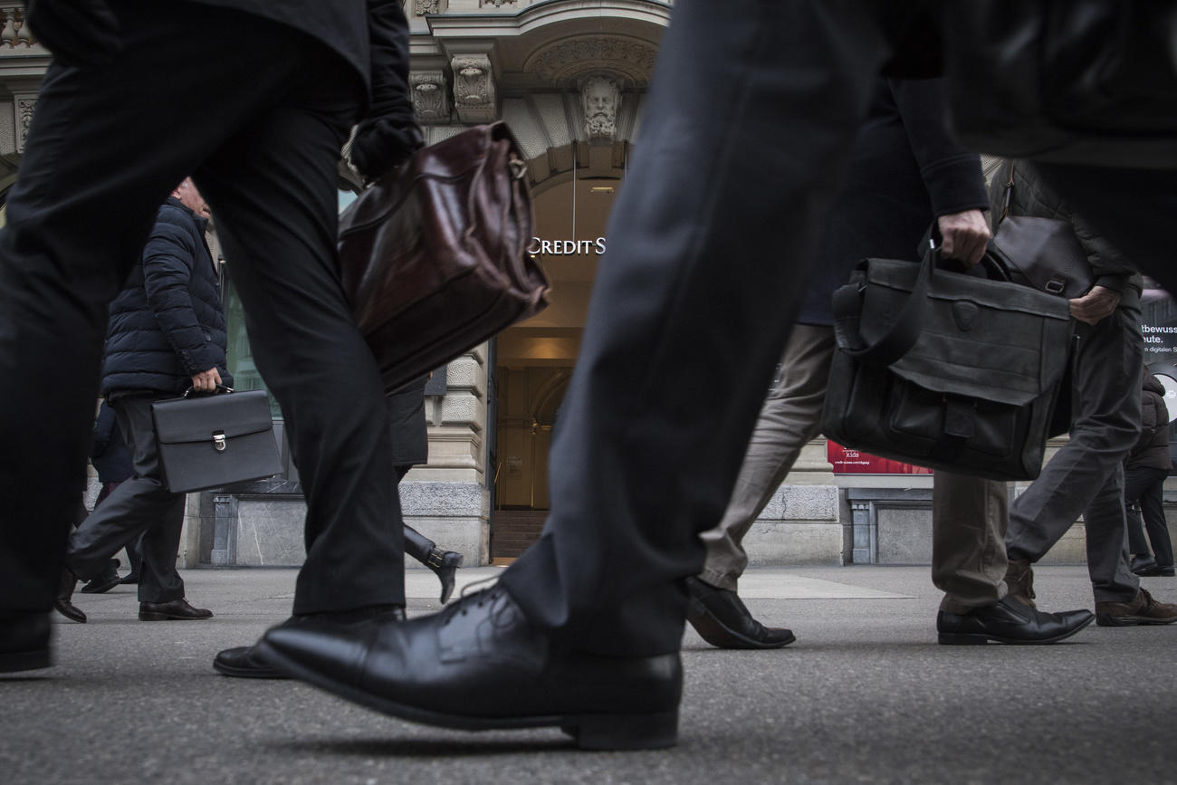 People in front of Credit Suisse bank