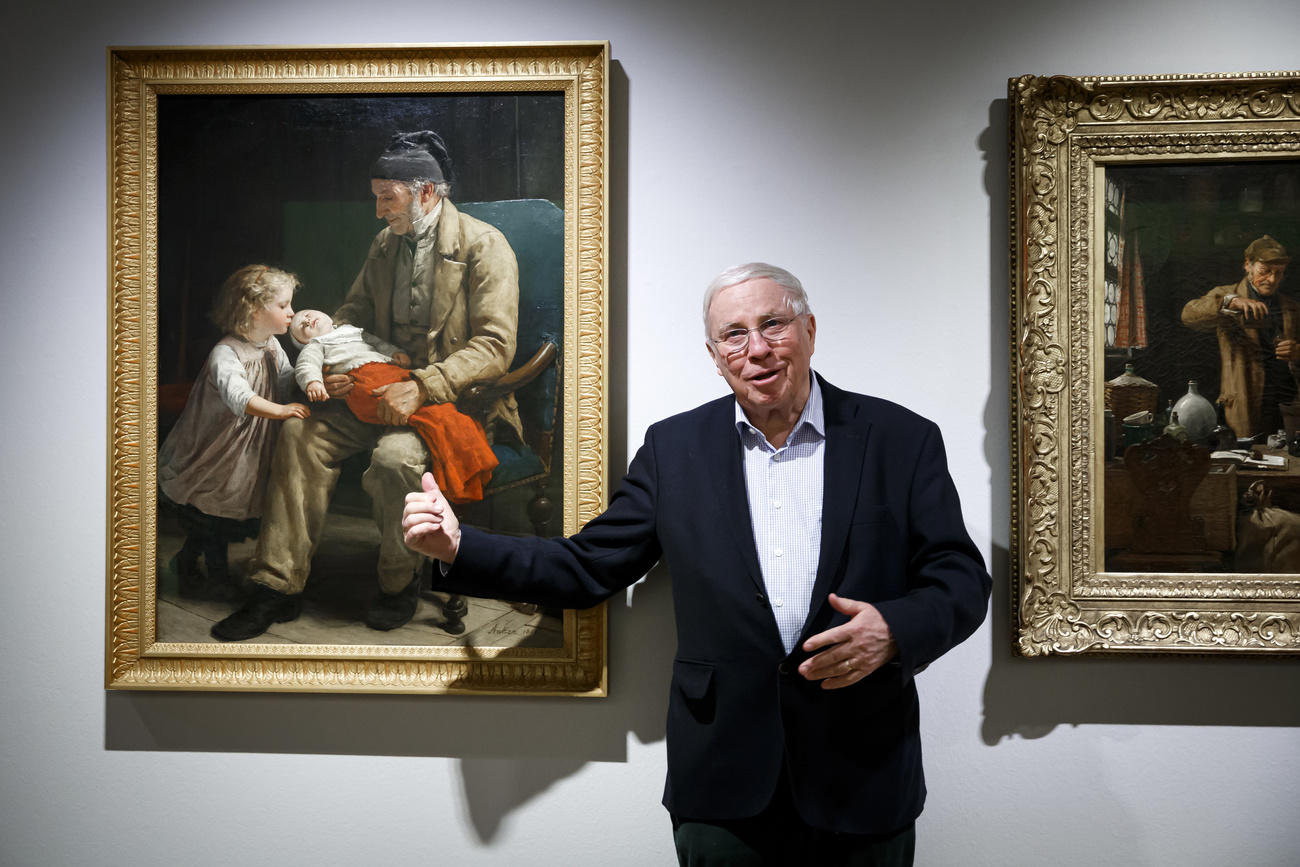 Christoph Blocher describes the painting Veillard et deux enfants (left) by Swiss painter Albert Anker