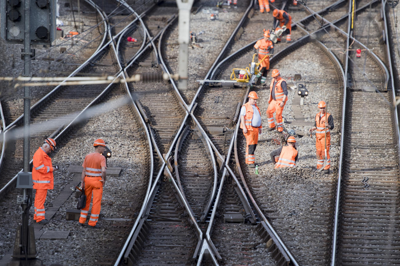Men work on railway tracks
