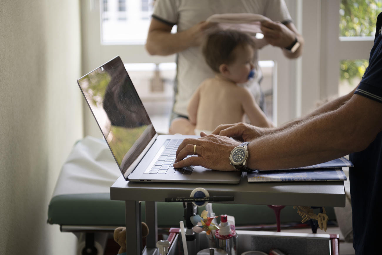 baby and doctor with laptop