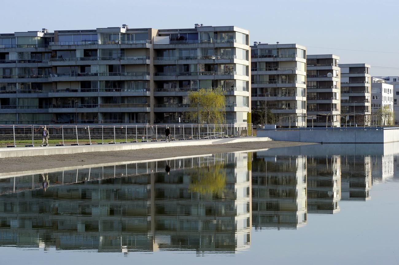 New apartment blocks reflected in a nearby pond