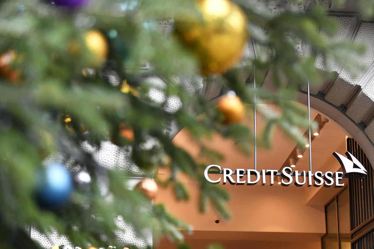 Credit Suisse sign framed by a Christmas tress