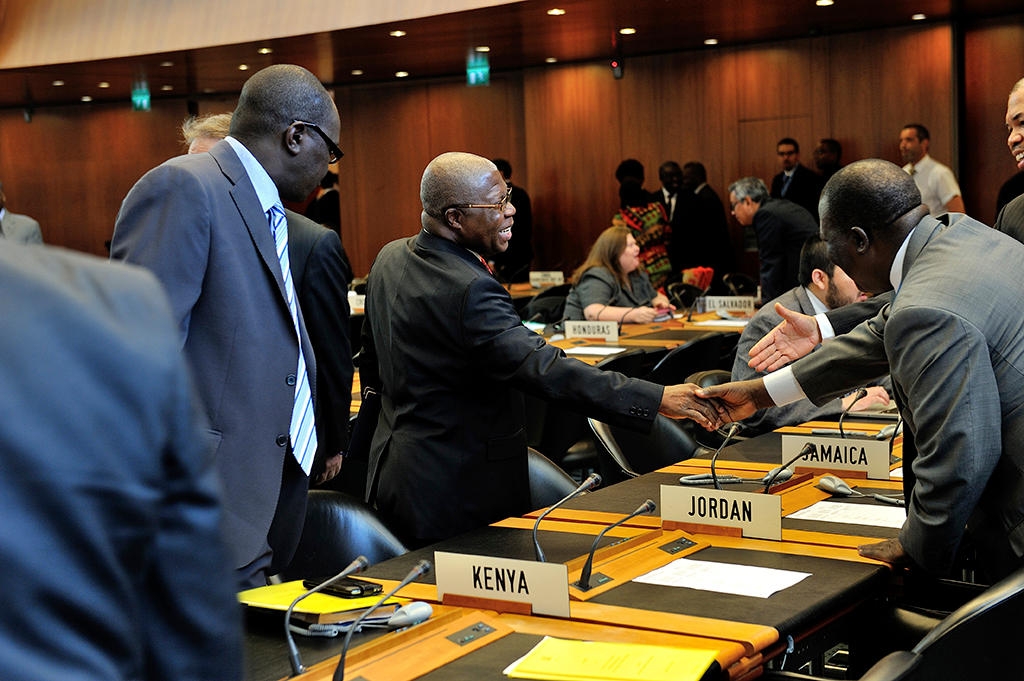 Delegates greeting prior to a meeting of the WTO s General Council.