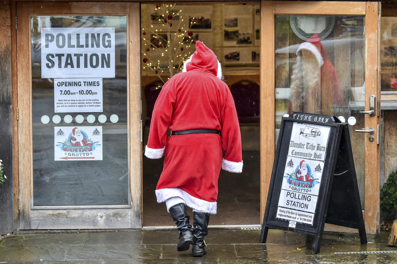 Father Christmas enters a polling station