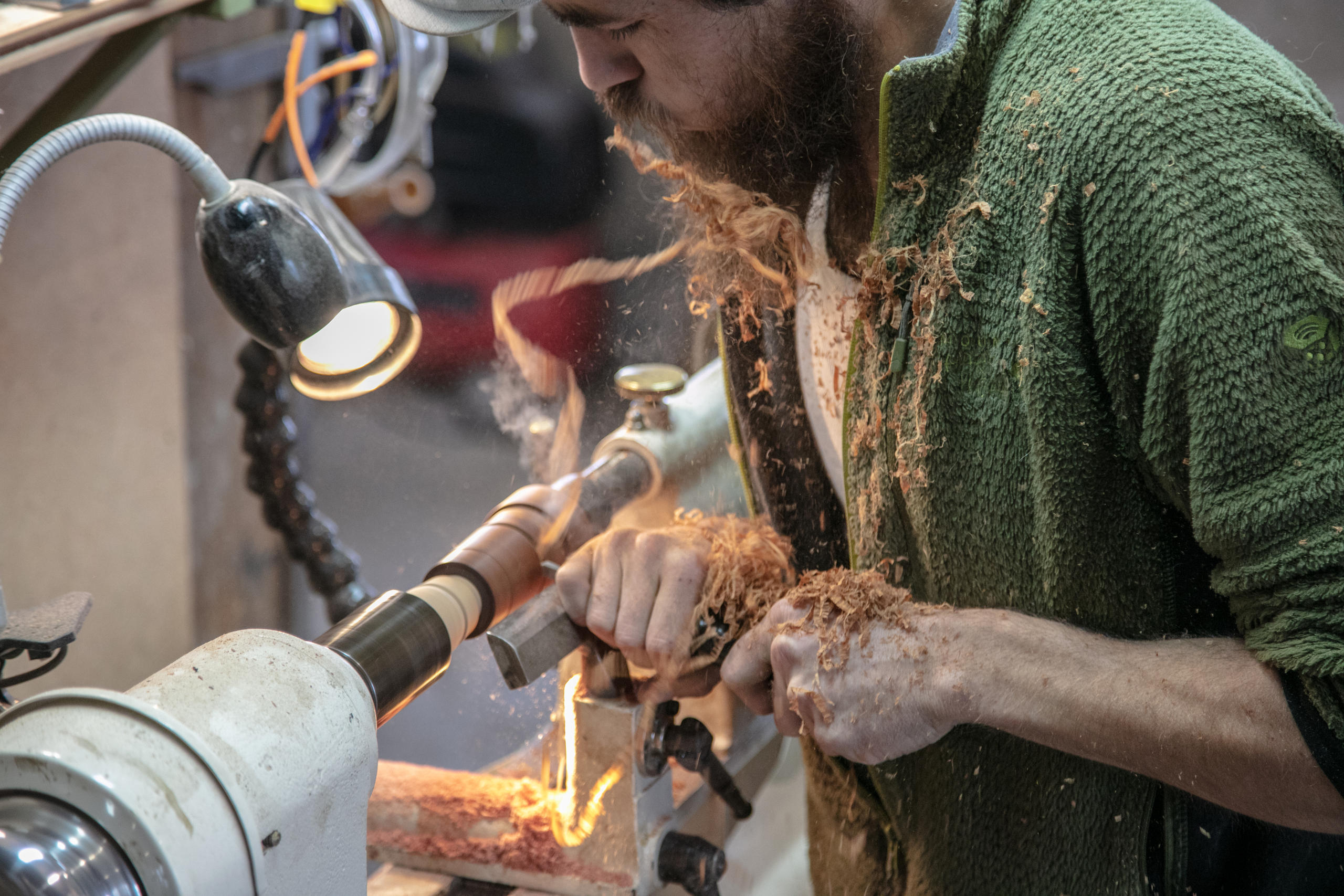 Sebastian works on the wood turning machine.