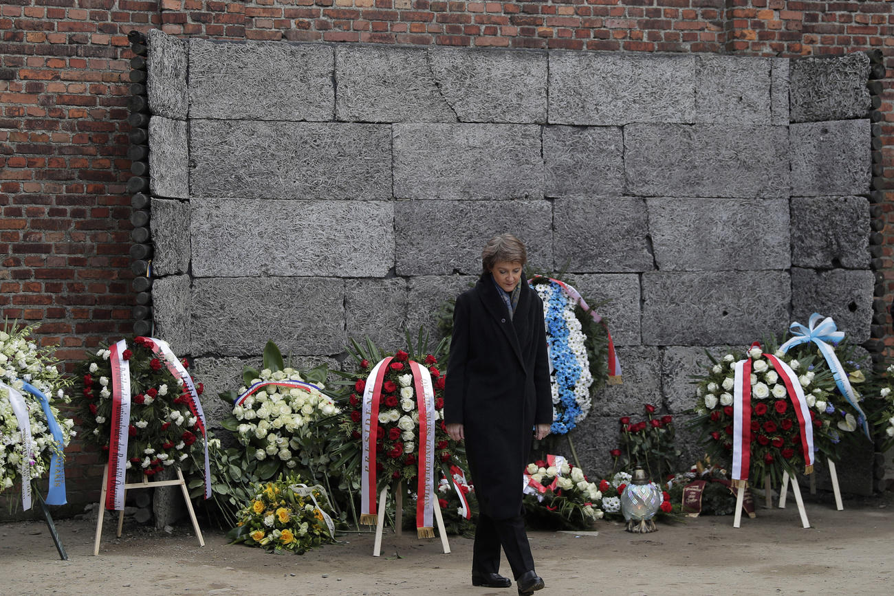 Switzerland s President Simonetta Sommaruga walks away after laying a wreath at the Death Wall at the Auschwitz