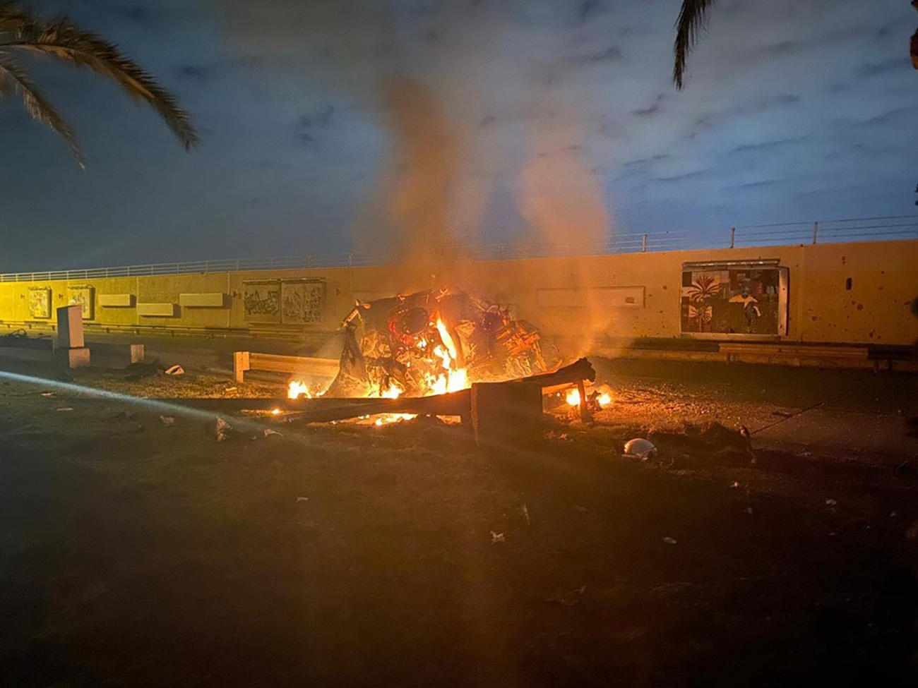 Burning car and crater