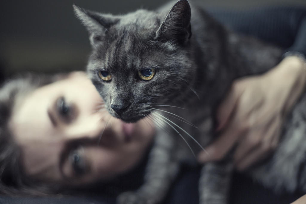 woman cuddling cat