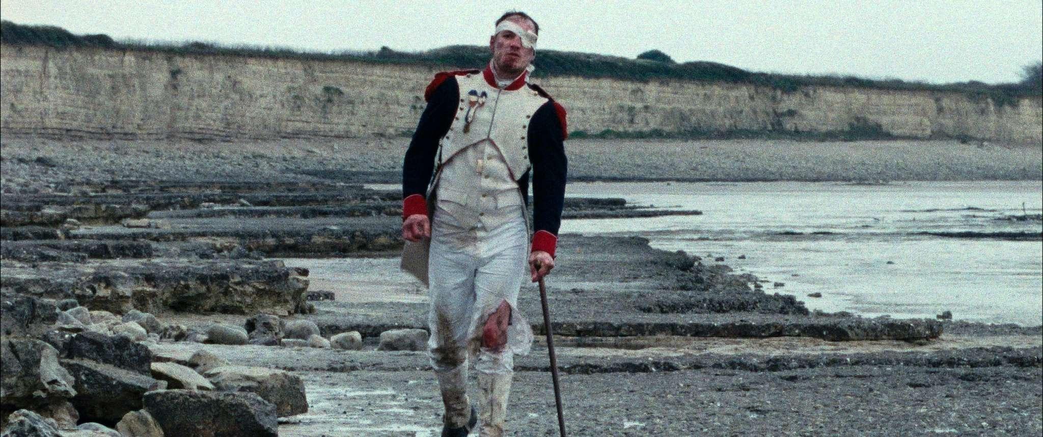 Wounded soldier walking on a beach