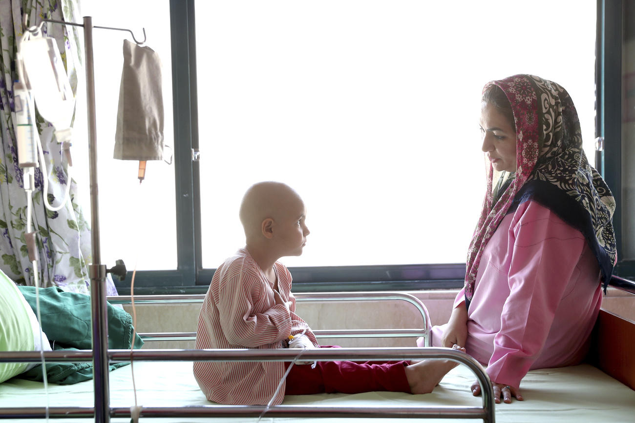 Boy with cancer in hospital with his mother