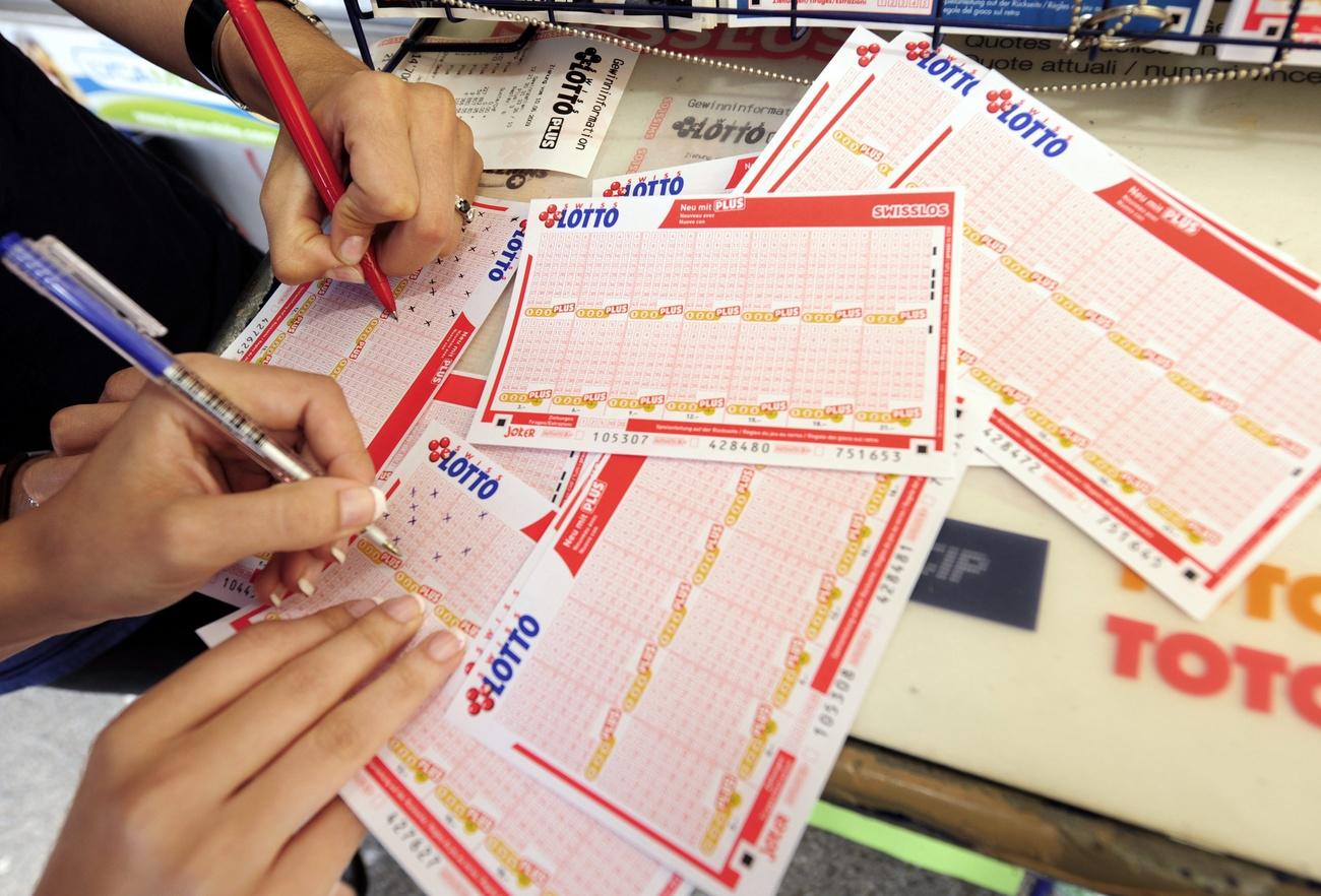 People filling in lottery tickets