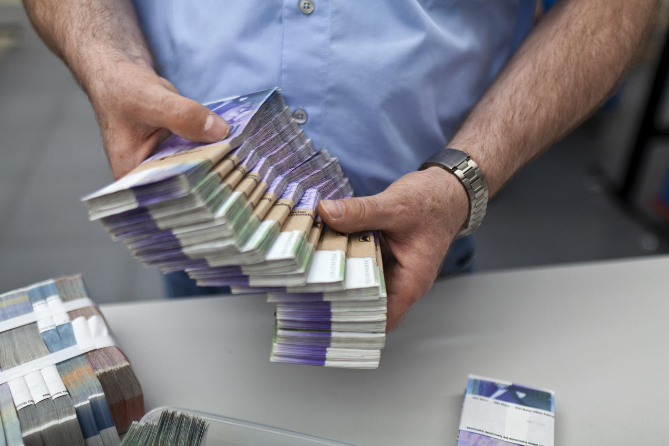 Man holding wads of money