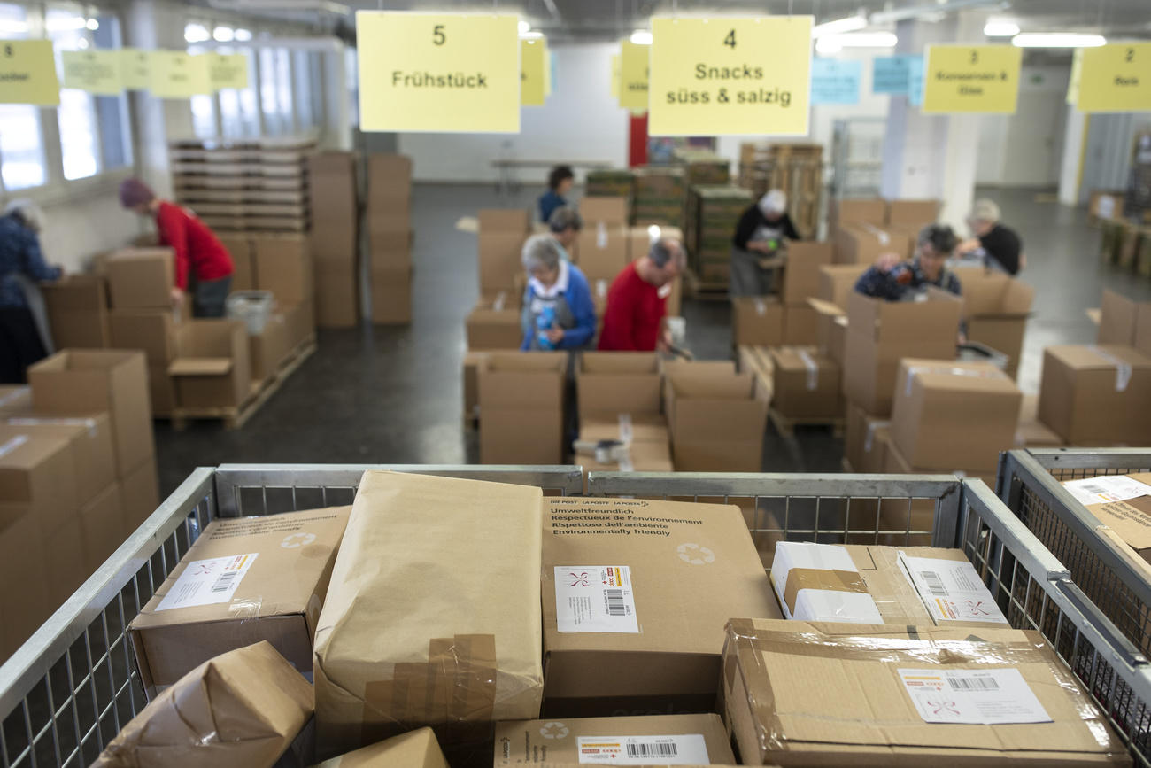 Donated parcels are ready to be unpacked by volunteers at the Swiss Red Cross logistics centre in Bern