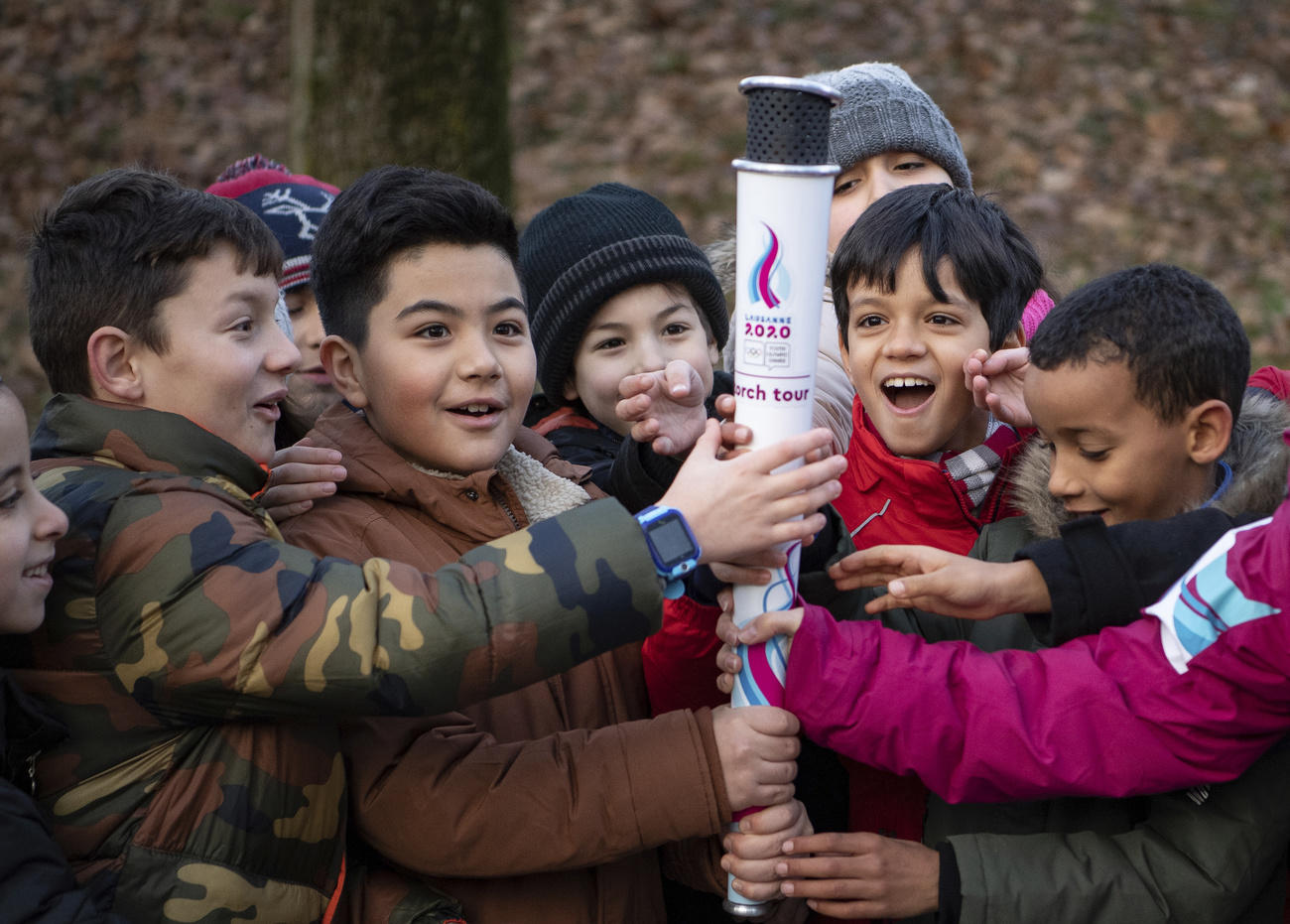 Children holding the Olympic flame