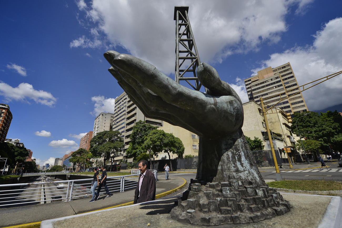 statue of a hand holding an oil well