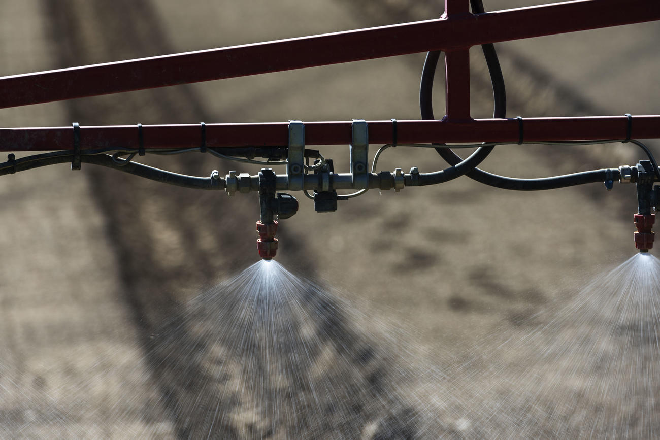 iew of a part of an field sprayer system attached to a tractor