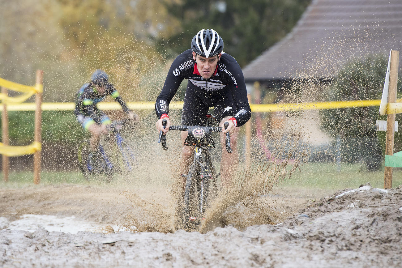 man riding bike in mud