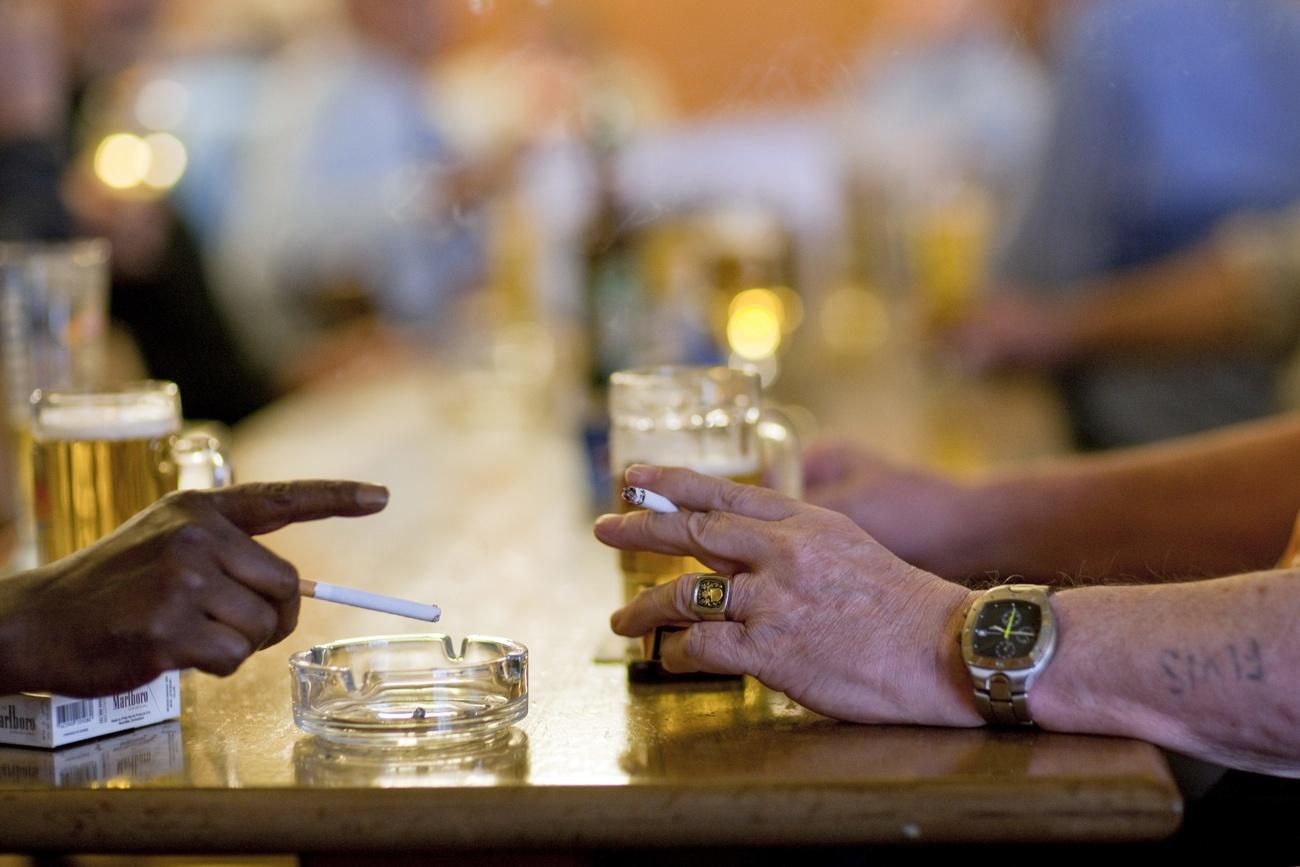 Two people smoking in a bar