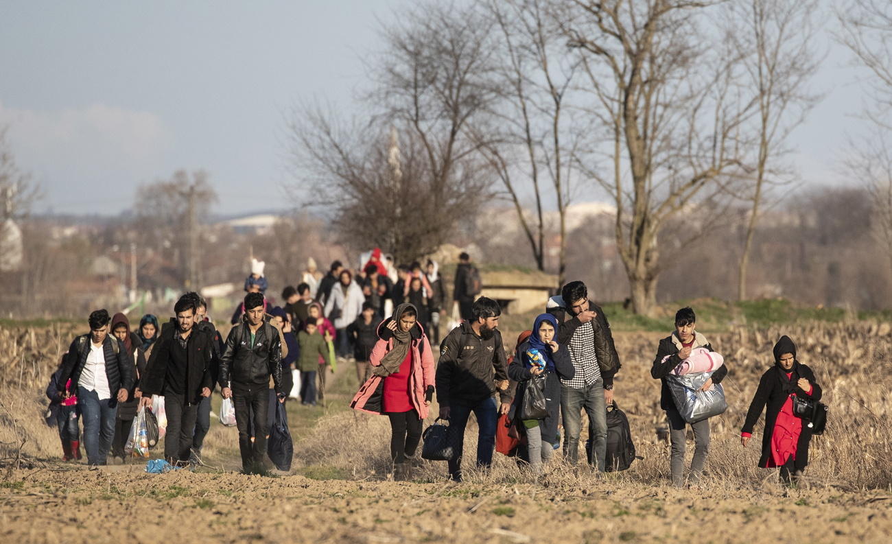 Syrian refugees walking in a field