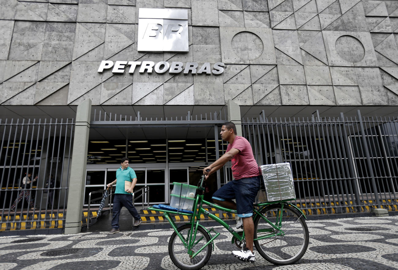 A man cycles past the Petrobras headquarters in Brazil.