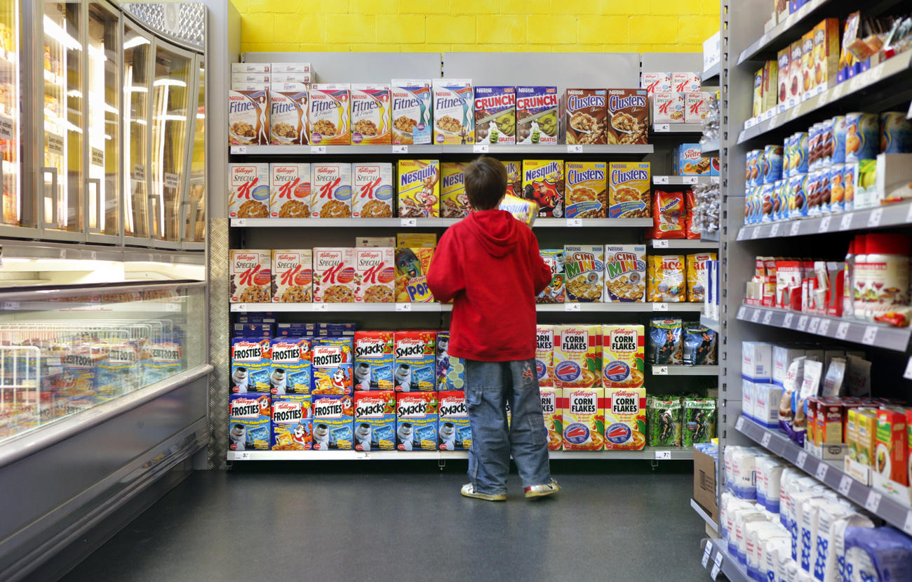 Young man standing in front of shop shelves