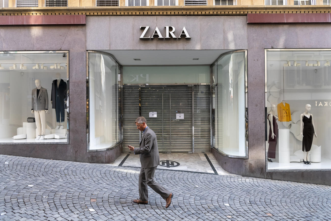 Man walks past shuttered store