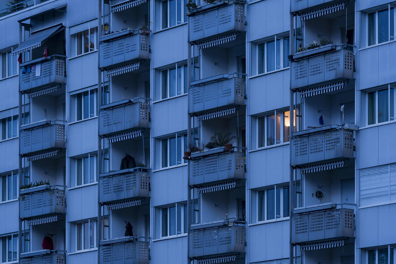 Apartment block at dawn, light in one window