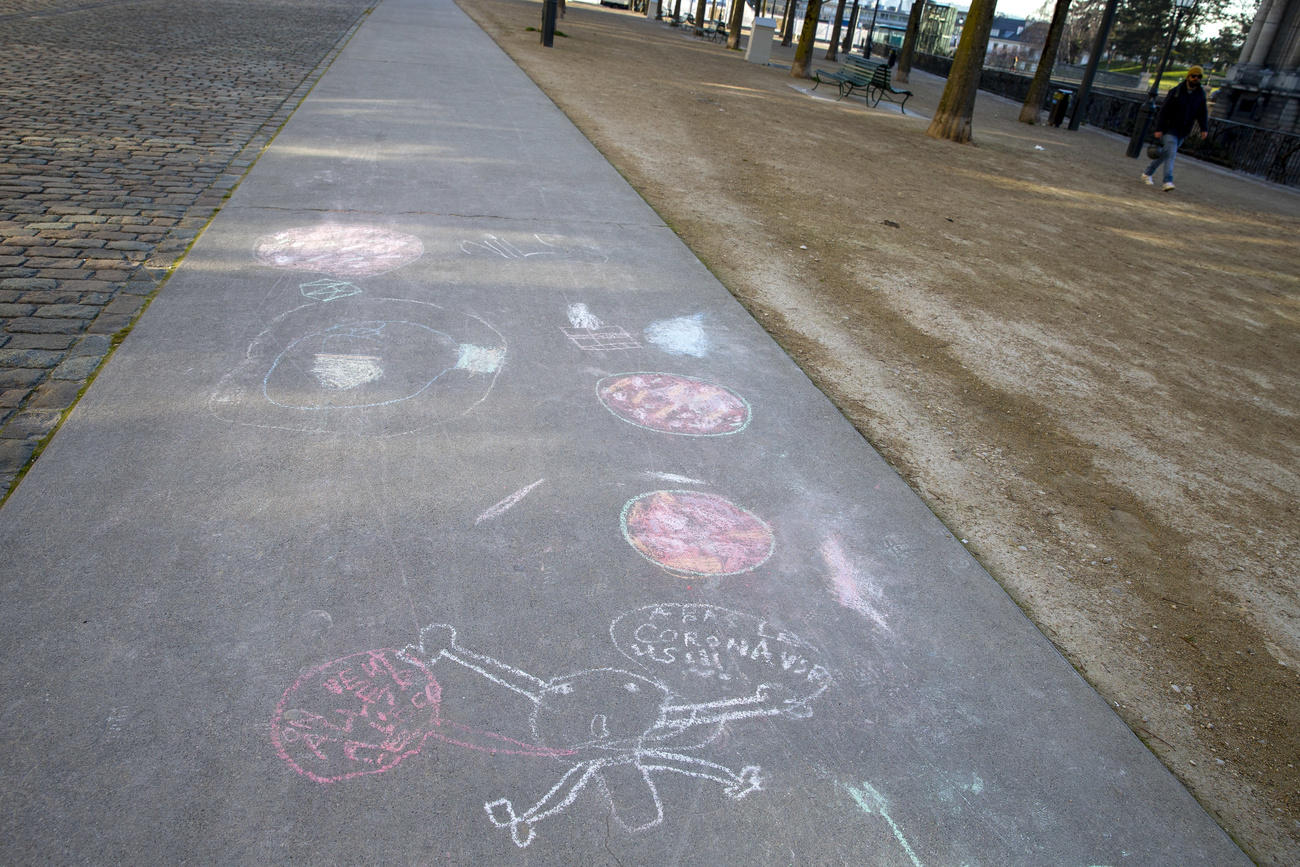 The coronavirus bacteria is drawn on a sidewalk