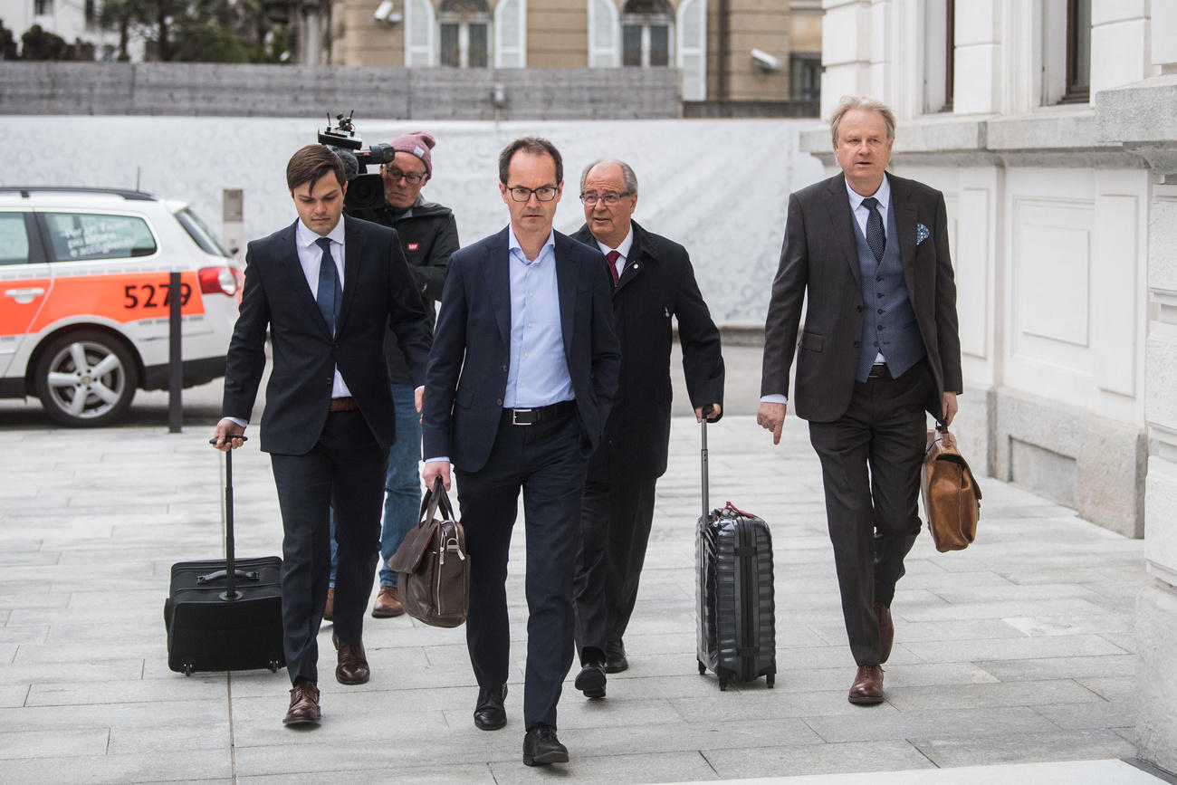 Four people outside a court building