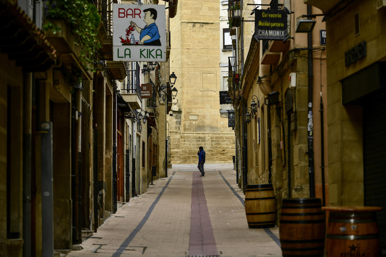 A pedestrian walks along an empty street in Haro, northern Spain, on March 9, 2020