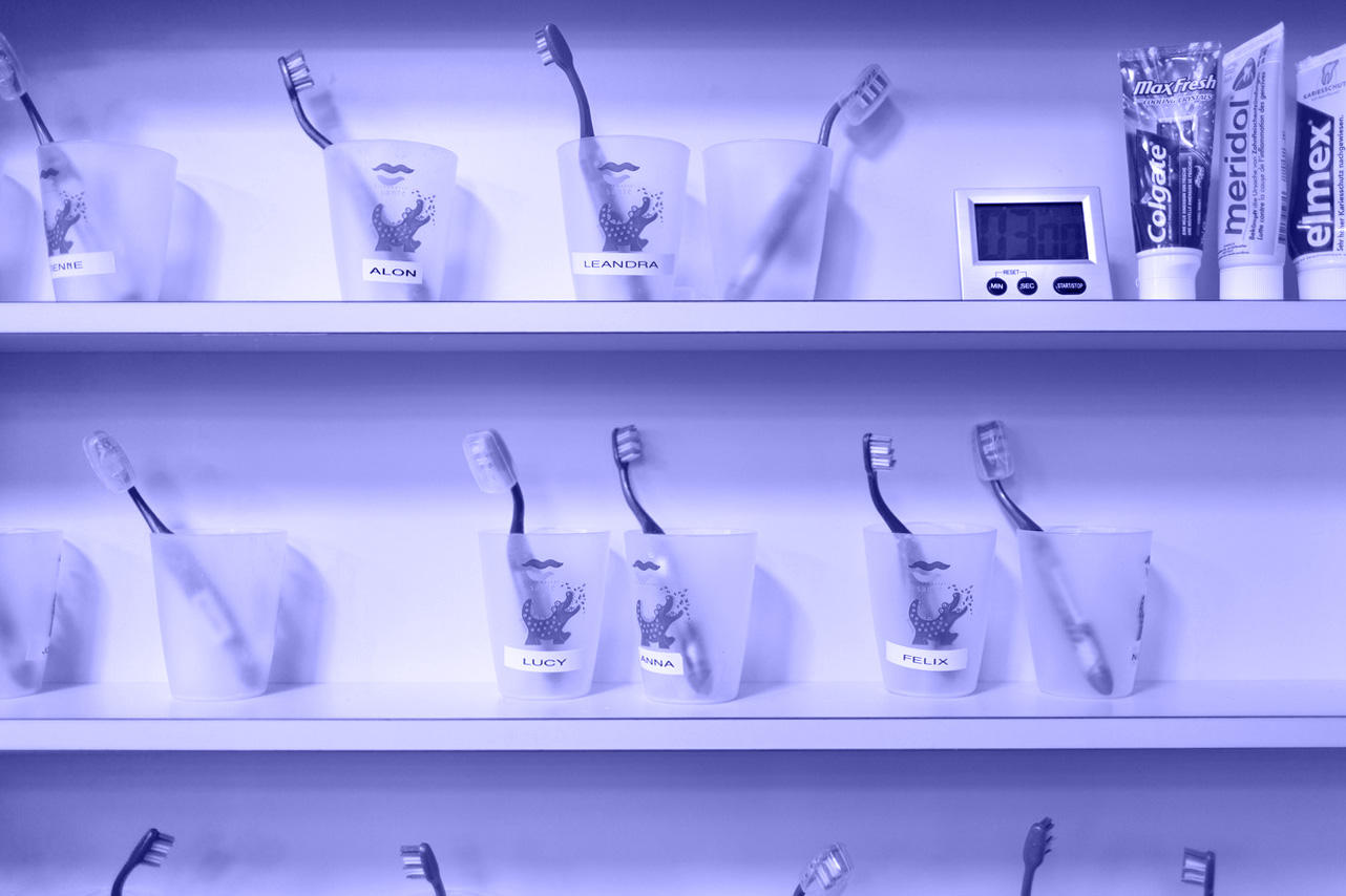 Beakers holding toothbrushes