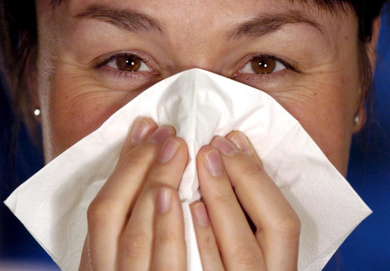 woman blowing nose