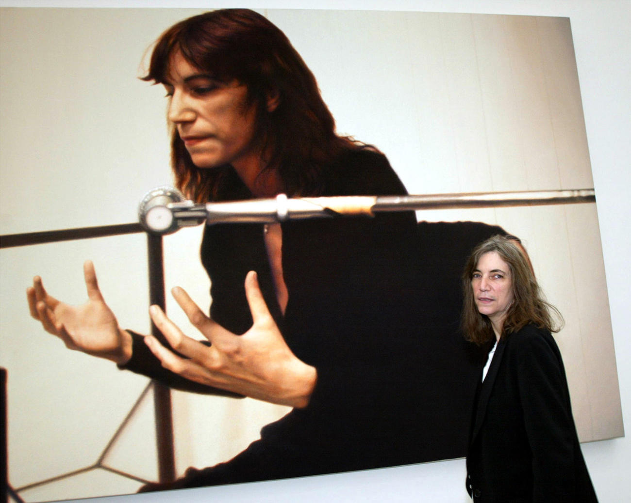 Patti smith in front of painting of Patti Smith