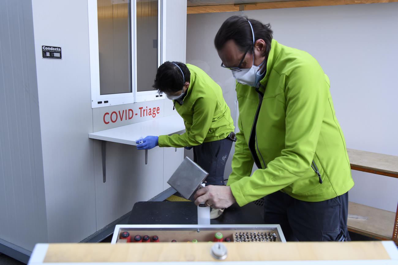 Two workers construct an information station.