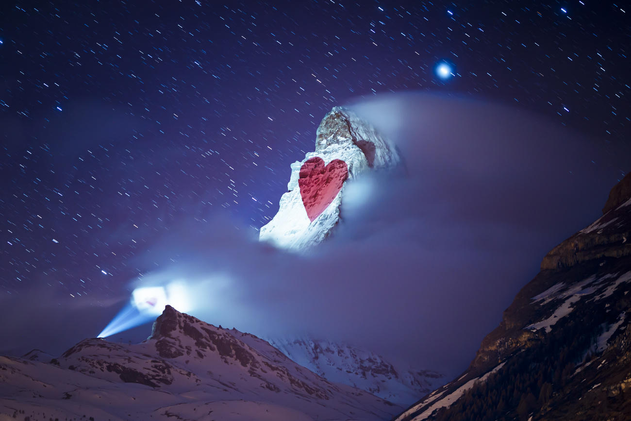 heart projected on snowy mountain