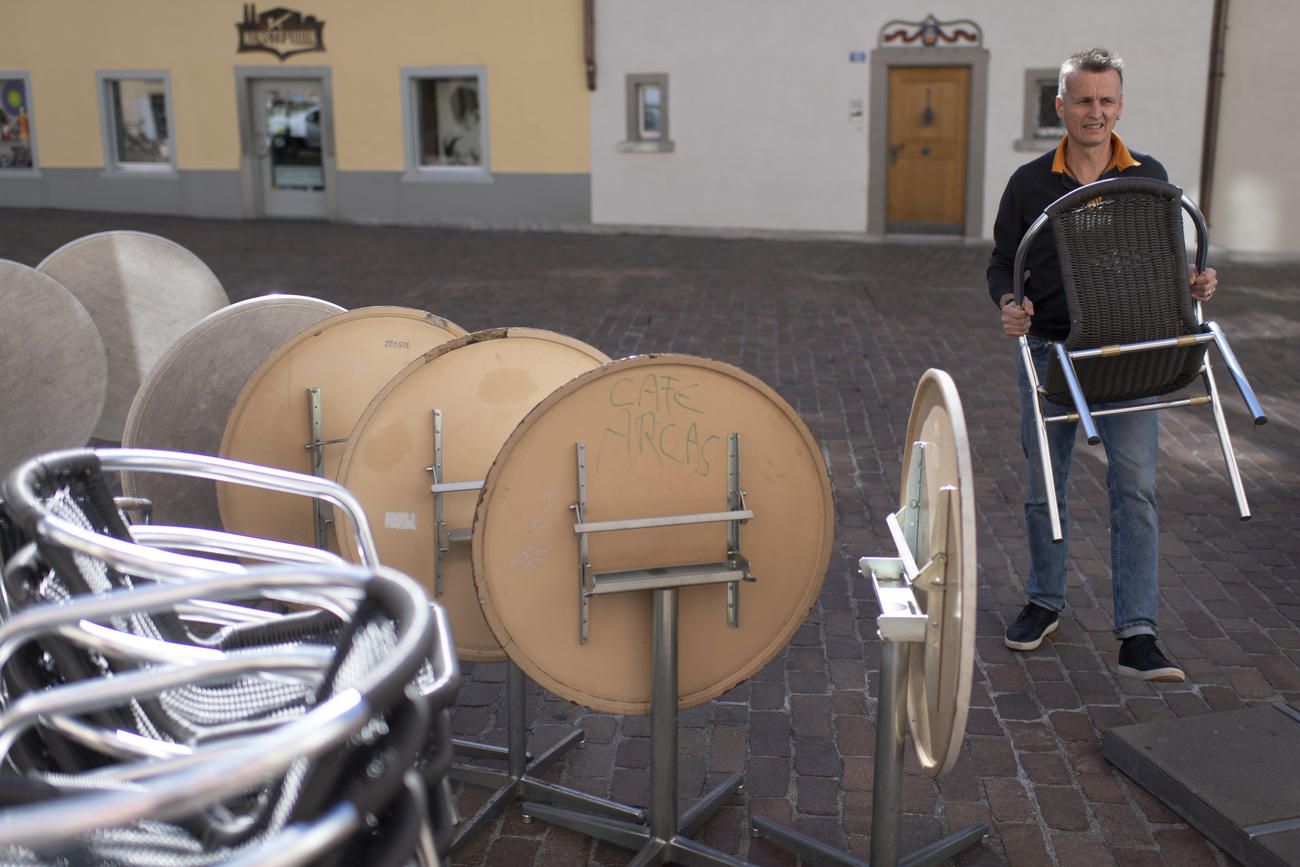 Man carrying a restaurant chair