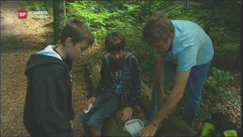 a man and two children in the forest