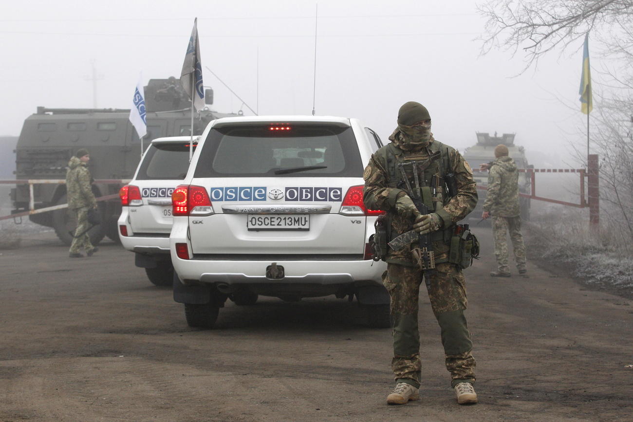 OSCE cars with Ukrainian soldier guard