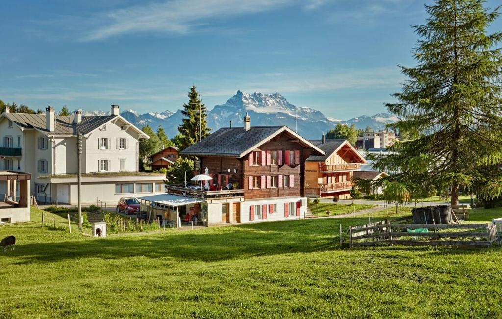 Wooden chalet with mountains in background