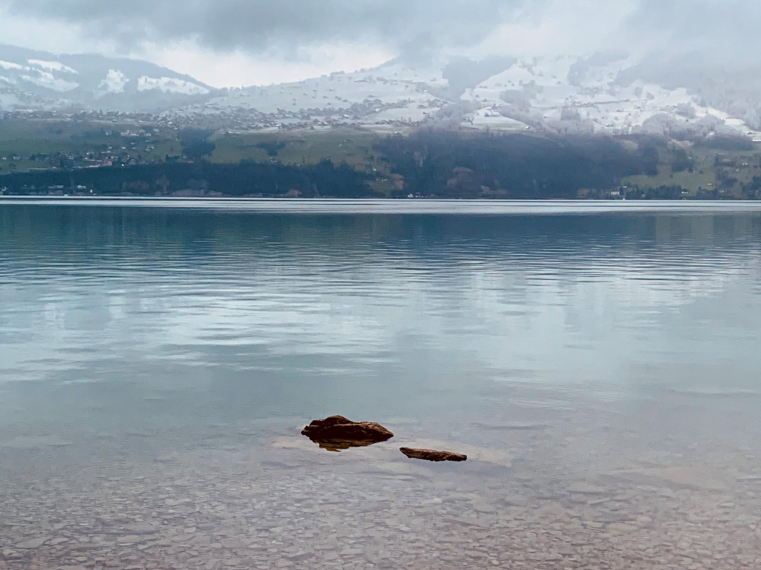 Lake with snow-covered mountains in background