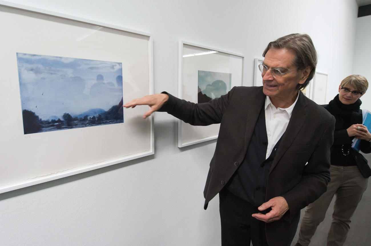 Raetz standing in front of print at Bern exhibition