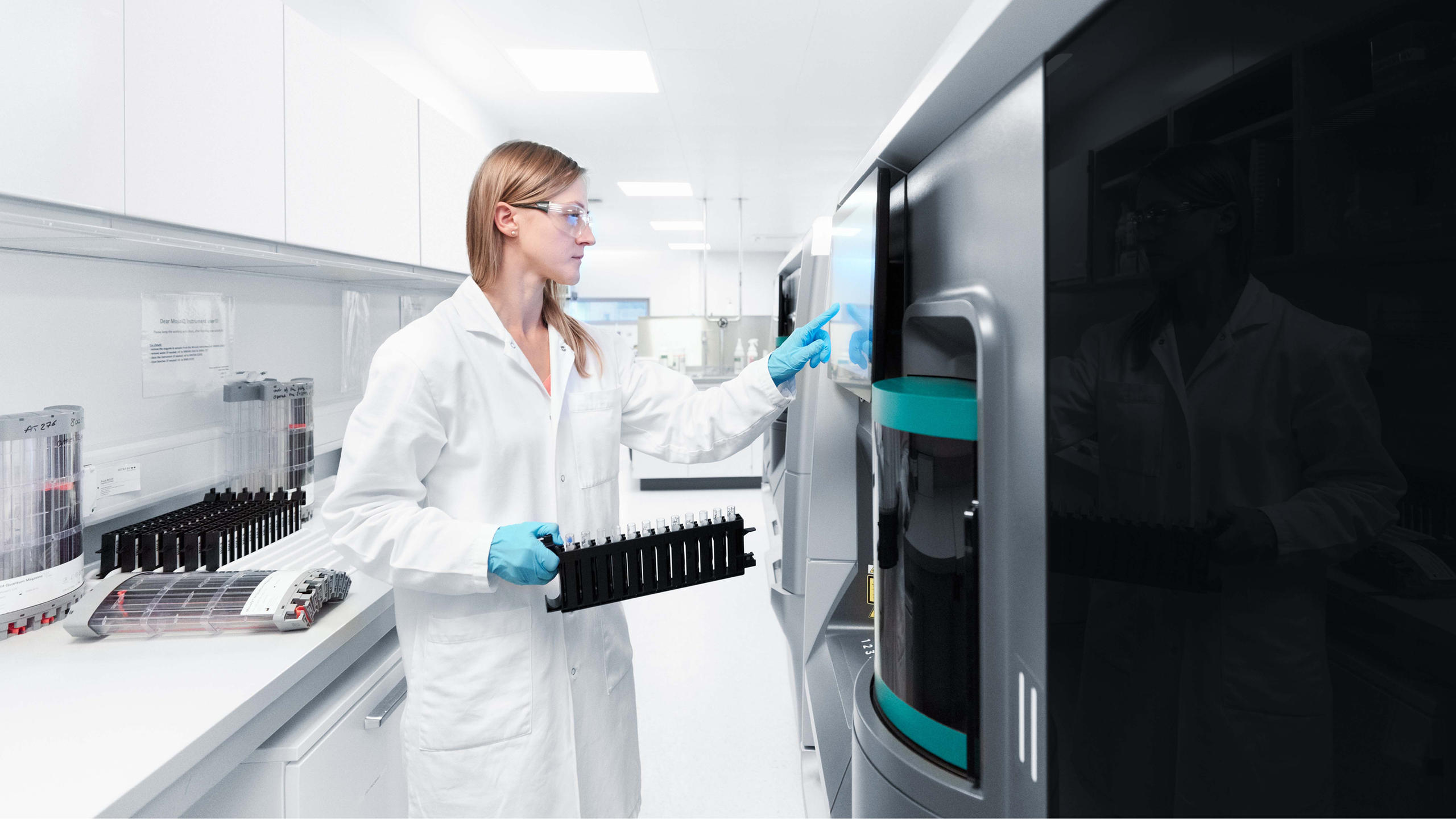 Woman in lab coat conducts test