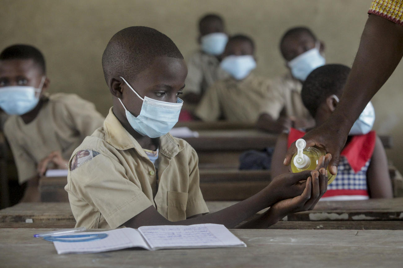 African schoolboy in mask