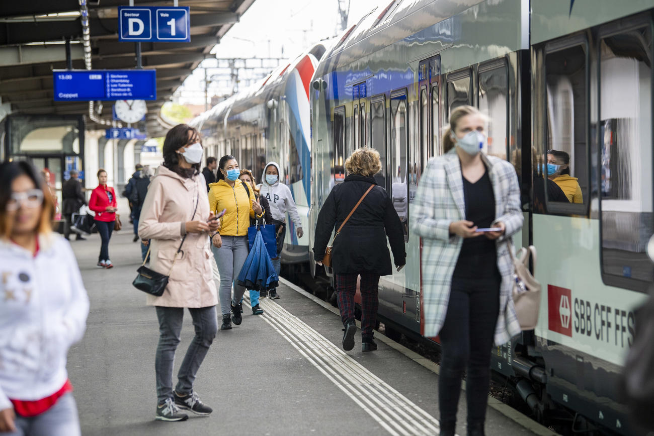 Train station with people in masks