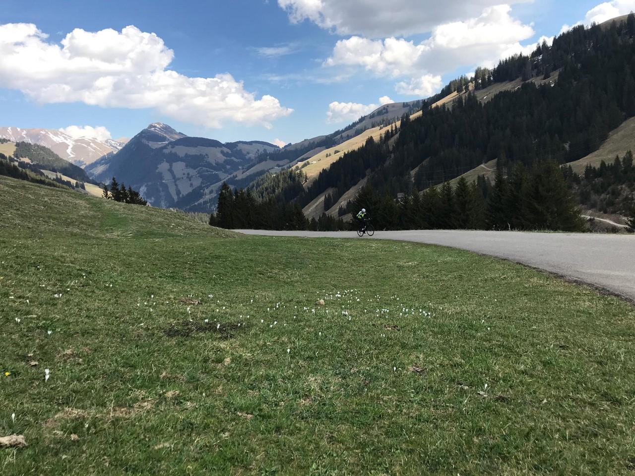 Mountain road with cyclist riding up