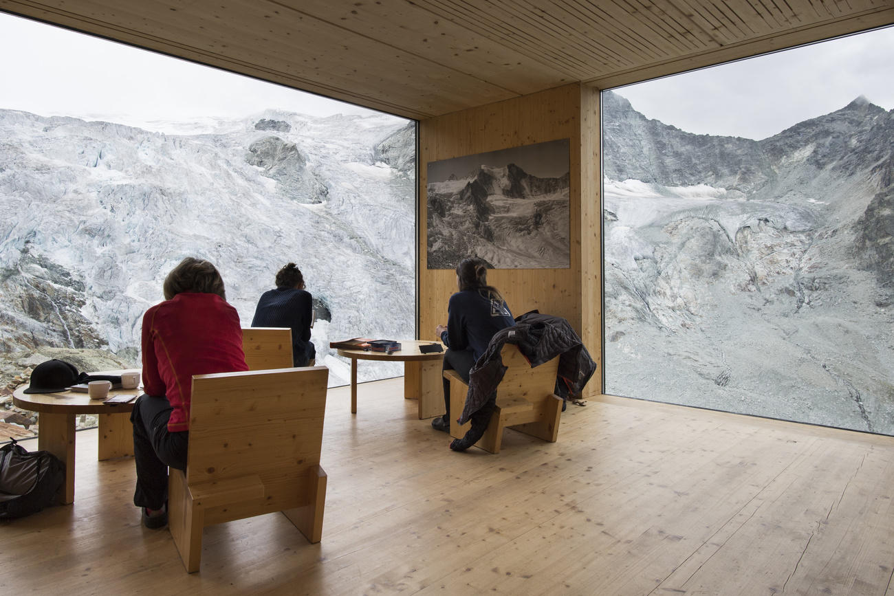 People enjoy the view of the Moiry Glacier the direction of the Moiry mountain hut