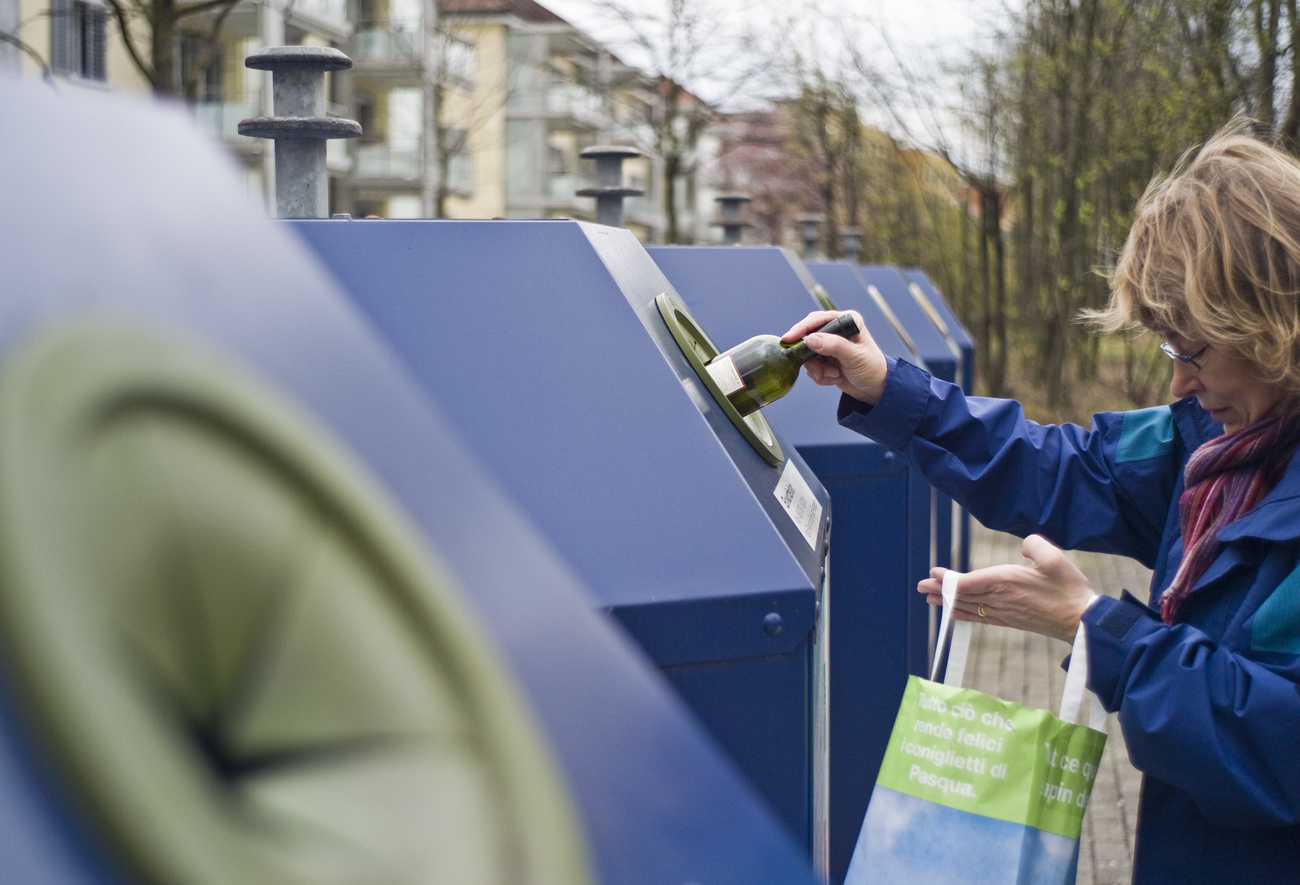 Woman recycling a bottle