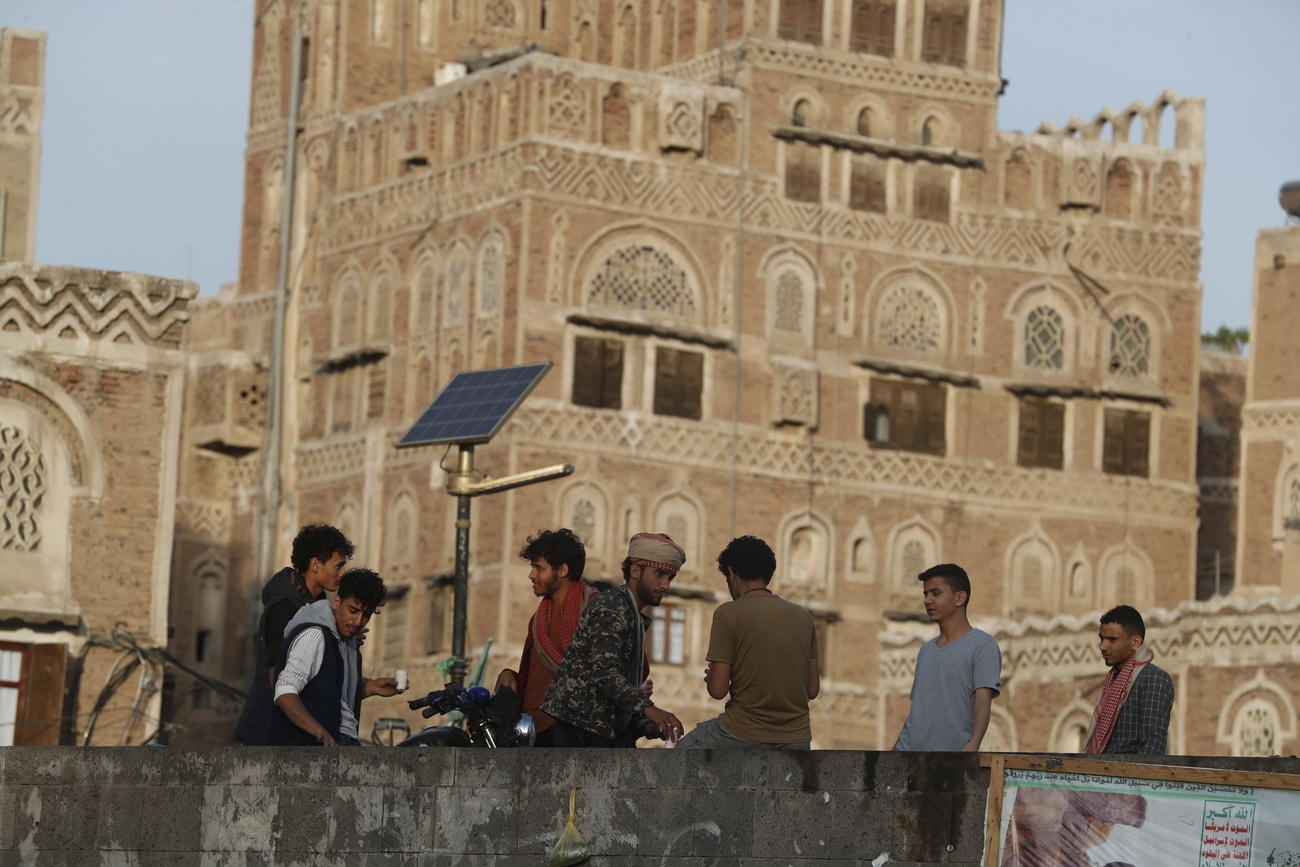 Yemenis gather at a pedestrian bridge in Sanaa